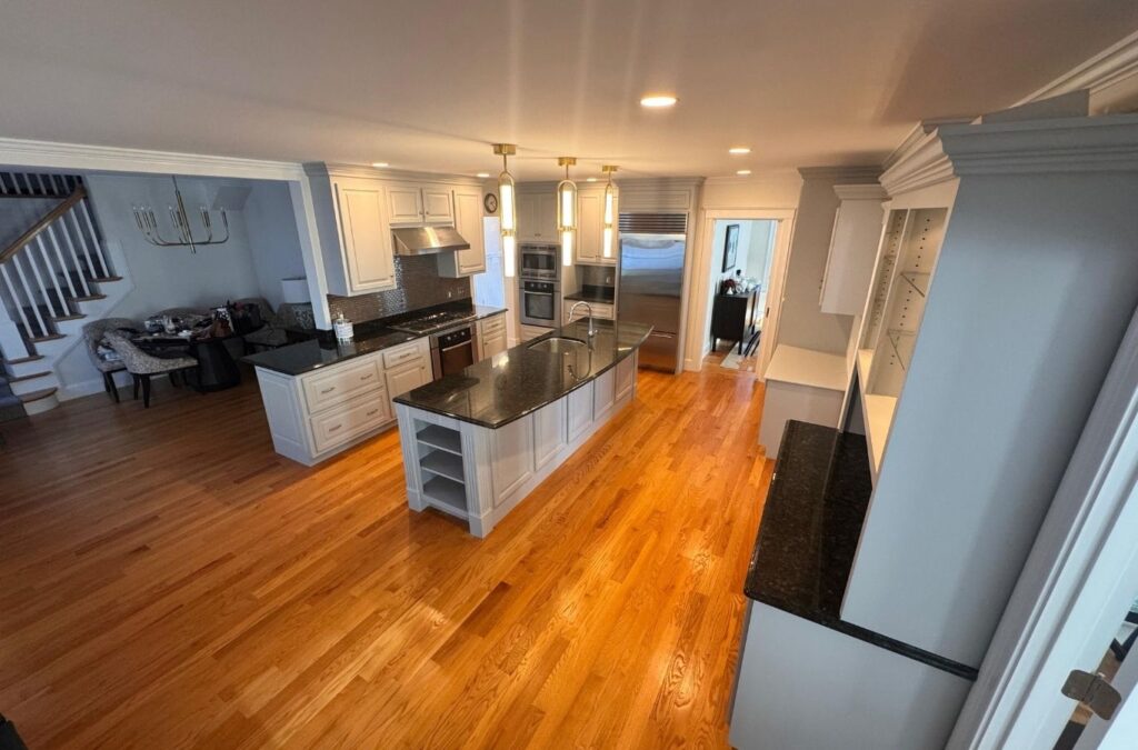 Experienced interior painter inspecting wall repairs and precise trim lines before final coat. Interior Painting near me.