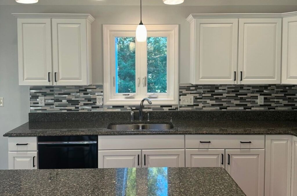 Painter cutting crisp lines along ceiling in freshly updated Grafton living room
