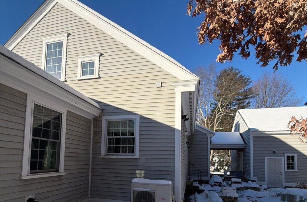 Crew painting Auburn home exterior trim after washing siding and protecting nearby landscaping
