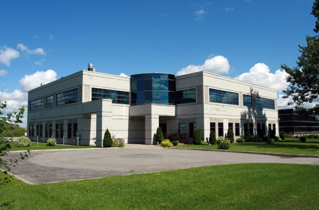 Stone office building beside a lawn, for Lucena Painting commercial painting in Holden, MA. Commercial Painting Near Me.
